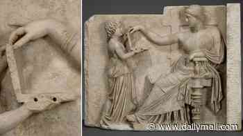 Ancient Greek statue holding a 'laptop' fuels surge in claims that time travel is real