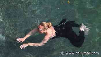 Adele cools off with a dip in the sea in wet suit leggings and goggles on her Amalfi Coast holiday