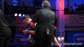 Darts star has to be helped off stage after suffering health scare during World Matchplay clash as he's forced to withdraw from tournament