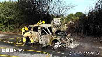 Fire destroys car and spreads to field