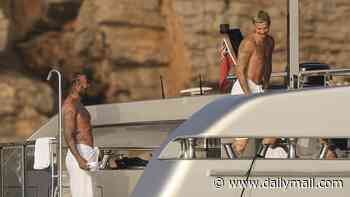 Romeo Beckham, 23, looks just like his famous dad David, 51, as they show off their shirtless tattooed torsos in matching towels on board Ibiza yacht with Victoria and Kim Turnbull