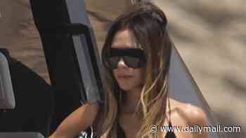 Victoria Beckham wears plunging sundress as she joins her family on board luxury yacht in Ibiza - after watching the World Cup in America
