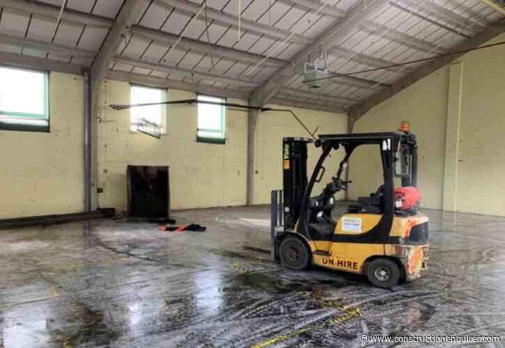 Worker falls from tipping bucket on fork lift