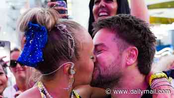 JoJo Siwa, 23, shares a kiss with boyfriend Chris Hughes, 33, as she leaps into his lap after he hinted he's ready to propose following whirlwind romance