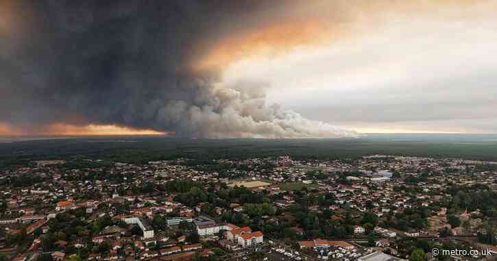 Raging wildfires force residents to flee their homes by boat