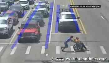 Spider-Man moonlights as good Samaritan, guides man in wheelchair across long crosswalk in Arkansas