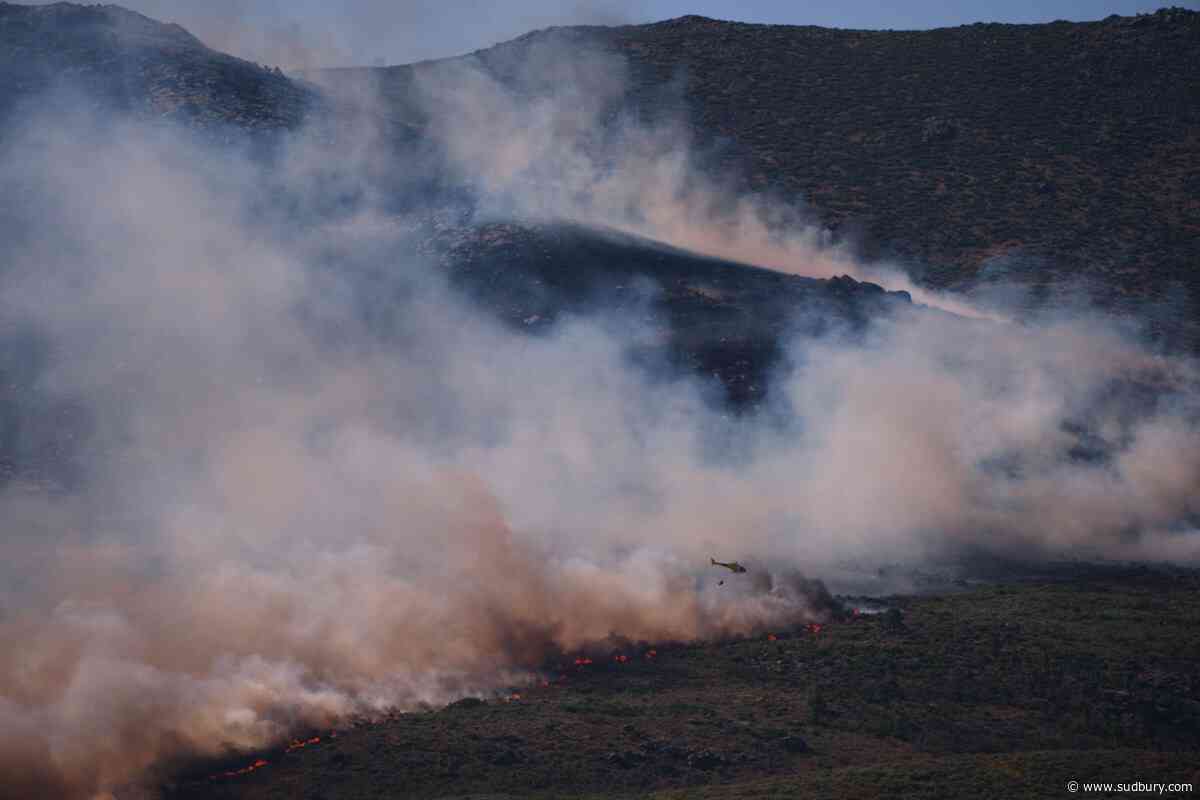 More than 200,000 people flee raging wildfires in France and Spain, some escaping by boat
