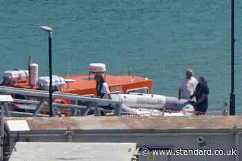 Migrants arrive after rowing tiny dinghy across the Channel