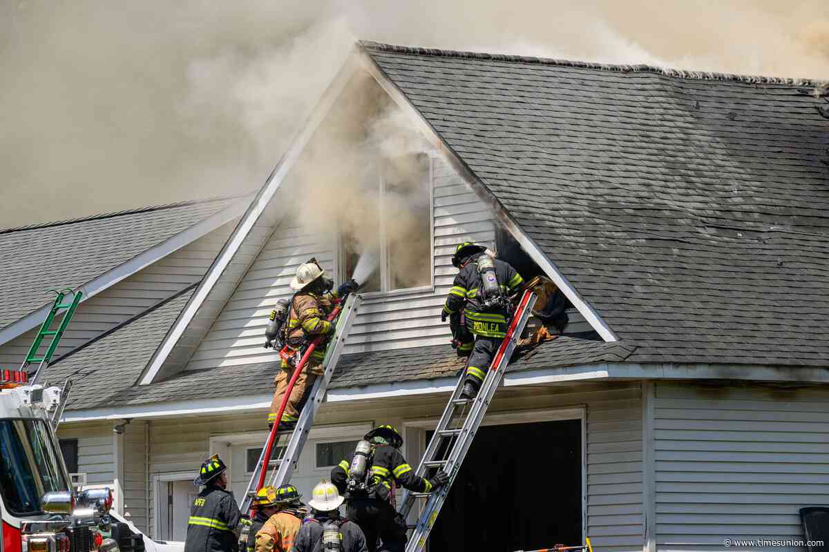 Photos: Fire tears through West Sand Lake garage