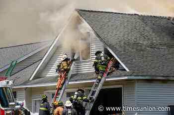 Photos: Fire tears through West Sand Lake garage