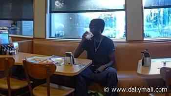 Alleged stabber's astonishingly casual response to being arrested as he lounges in IHOP and sips drink as cops try to cuff him: 'One moment'