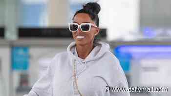 Katie Price continues to stick by conman husband Lee Andrews as she's seen with her wedding ring on after he was released from Dubai prison