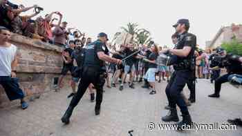 Armed riot police with shields clash with anti-tourism protesters in Mallorca as demonstrations turn violent