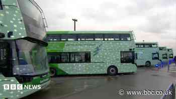Electric buses being charged by diesel generators