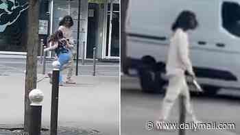 Moment knifeman lunges at woman during stabbing rampage that left three injured in Paris - before crowd pin him down with a chair