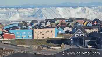Moment enormous iceberg capsizes triggering tsunami-like waves off coastal town in Greenland
