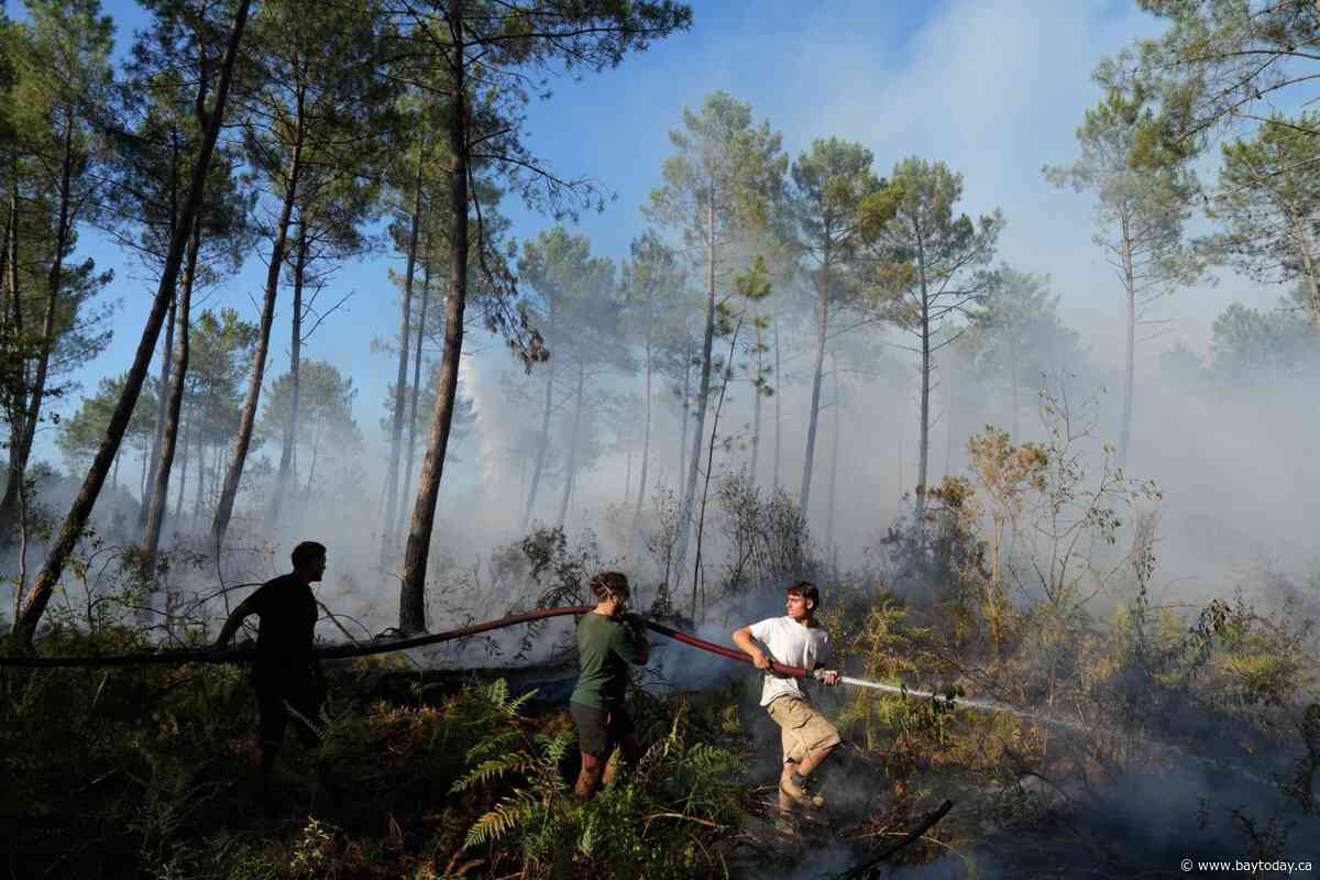 Firefighters in France try to hold back vast wildfire as heat returns to test their grip