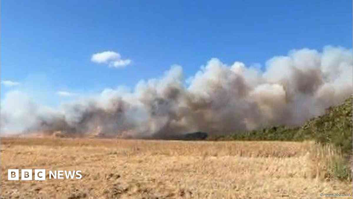 Crews tackle large crop fire near village
