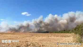 Crews tackle large crop fire near village