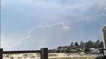 Dramatic moment bolt of lightning form heart shape over Cannon Beach