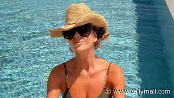 Amanda Holden, 55, shows off her age-defying figure in a tiny green bikini as she soaks up the sun in Corfu