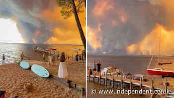 France wildfires turn skies apocalyptic orange as beachgoers watch on