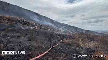 Major road remains closed as crews tackle wildfire