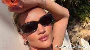 Rosie Huntington-Whiteley flaunts her incredible figure in skimpy bikinis as she relaxes on family holiday to Malta and gives rare glimpse of her daughter