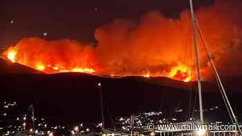 More European tourism destinations are hit by wildfires as villages are evacuated on top Greek holiday island and France battles flare ups in 40C heat
