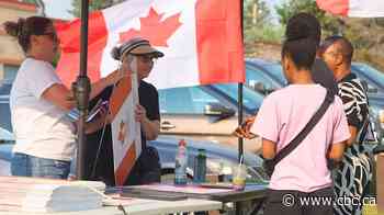 ‘Where I needed to be’: For these pro-unity volunteers, handing out signs is a way to lift their spirits