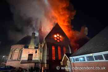 Firefighters race into burning church to rescue coffin from devastating fire