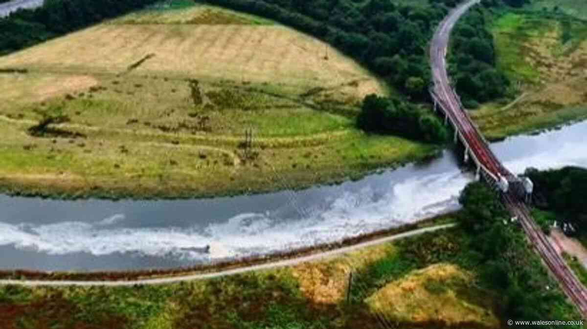 Huge snaking mass of scum travelling down Welsh river and the smell is making people's eyes burn