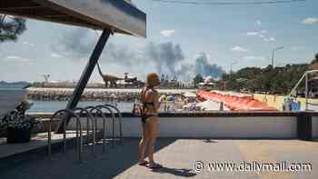 Ukrainian tourists sunbathe as Putin's bombs rain down near Black Sea beach resort