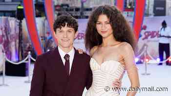 Zendaya stuns in a plunging white gown with silver web design as she joins husband Tom Holland at the Spider-Man premiere - as impressed fans declare 'Marvel is SO back!' in first reviews