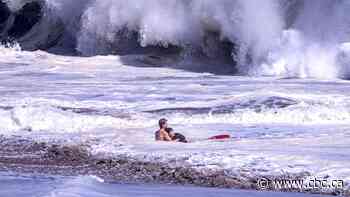 Lifeguard battles massive waves to rescue a child | The Moment
