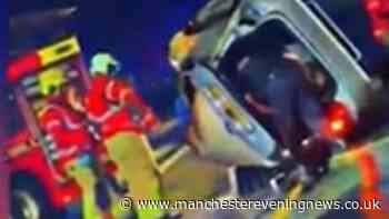 Large emergency response after car flips over in crash on busy Manchester road