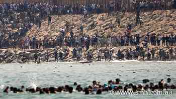 ‘Absolute chaos’: Thousands of people rush across Moroccan border, hoping to get to Europe