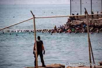 Spain deploys military to Ceuta after thousands of people breach Morocco’s border and at least 9 die