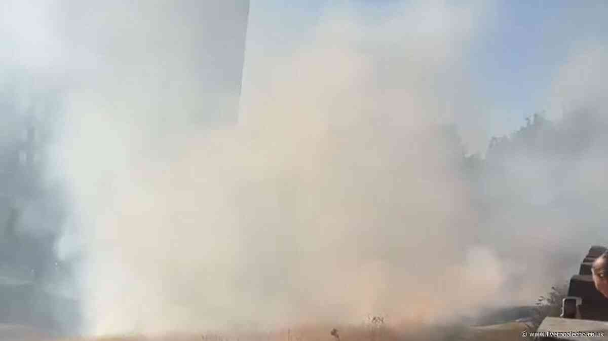 Thick smoke billows as firefighters tackle grass blaze in Everton
