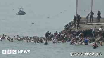 Migrants seen swimming around border fence of Spanish enclave Ceuta