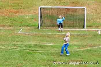 Model village removes topless streaker from football pitch after families complain