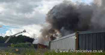 Dozens of firefighters tackle major Washington factory fire with black smoke seen for miles