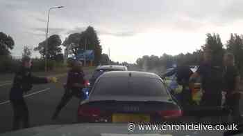 Dramatic moment teenage driver is dragged out of Audi window by police after 140mph chase