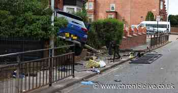 Unconscious person taken to hospital after car smashes into house on busy North East road