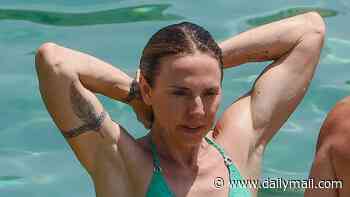 Mel Sea! Sporty Spice shows off her jaw-dropping abs in a green bikini as she enjoys boat day with her new husband Chris Dingwall during Ibiza honeymoon