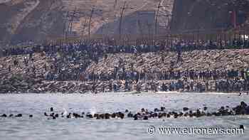 Thousands of migrants storm Ceuta border from Morocco