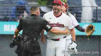 MLB benches clear in rainy Cleveland as grounds crew rushes to unfurl tarp amid chaos: 'It's a first for me'
