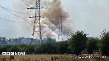 Fire crews tackle grass fire near motorway