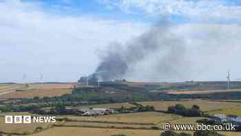 Firefighters tackling large fire near road