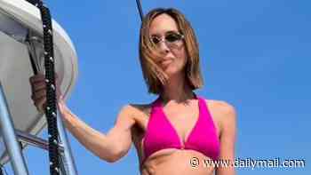 Myleene Klass, 48, looks joyous as she models a number of bikinis during a celebratory yacht trip after 'terrifying' breast cancer scare